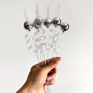 Detailed close-up of disco ball mirrored sphere ornaments on spiral party straws