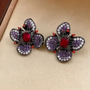 Vintage butterfly floral earrings with dark metal and deep red rectangular gemstones