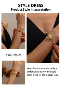 Detail view of gold-plated stainless steel flower pearl and bow open bangle on wrist