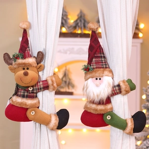 Detail of Christmas curtain buckles featuring plush Santa and elk with plaid clothes