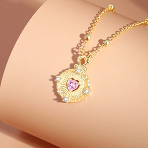 Pink heart-shaped gemstone necklace with gold chain and sparkling crystal accents