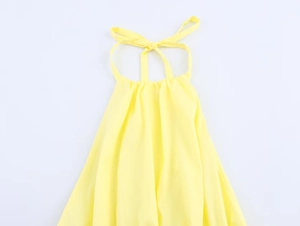 Detailed view of yellow halter neck top featuring adjustable tie-up neck straps