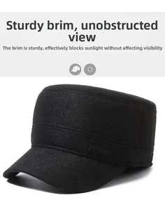 Detail of the stiff brim and sport patch on a black winter flat cap for outdoor use