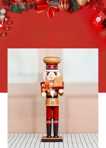 Detail of gingerbread man and miniature house on nutcracker tray with festive chef outfit