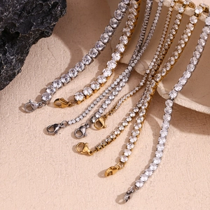 Close-up of gold and silver tennis bracelets with micro-paved zircons on stone background