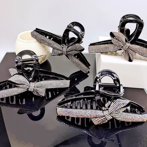 Detail of high-end black hair claws with luxury sparkling rhinestone butterfly patterns