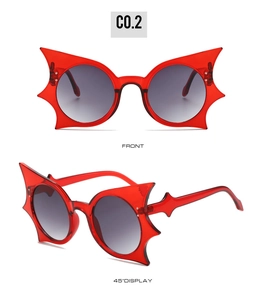 Front and 45-degree views of red bat-shaped hip hop sunglasses with unique frames
