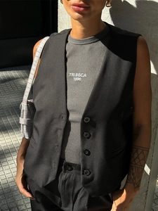 Detail of black tailored vest over a grey Tribeca 1996 tee with a crocodile texture bag