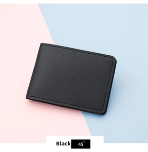 Detail of ultra-slim black card holder with lychee grain texture and neat stitching