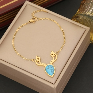 Gold stainless steel antler necklace featuring a pear-cut turquoise gemstone pendant
