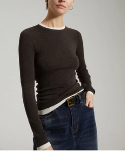 Close-up of contrast trim details on dark brown slim-fit wool knit sweater sleeves