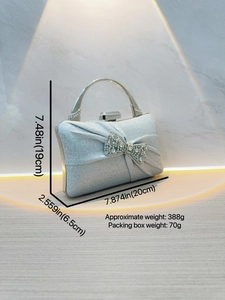 Silver pleated evening clutch bag with sparkling rhinestone bow and metal handle