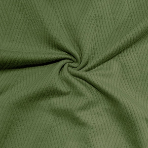 Détail macro du tissu tricoté vert olive montrant des motifs à chevrons clairs