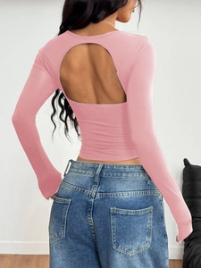 Macro detail of the backless design and elastic fabric on this pink Y2K long sleeve top