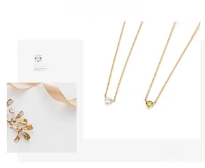 Detail of heart-shaped zircon pendant necklace with elegant gold chain and prong setting