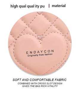 Macro view of heart-shaped quilted stitching on pink high-quality PU leather wallet