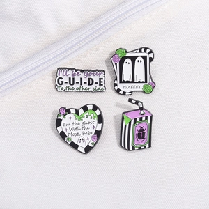Gothic ghost enamel pins set with Beetlejuice quotes on white canvas bag detail