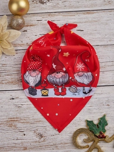 Close-up of red Christmas pet bandana featuring three festive gnomes on a wooden background