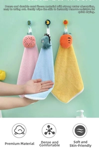 Detail of coral fleece hand towels with cartoon patterns and hanging loops for quick drying
