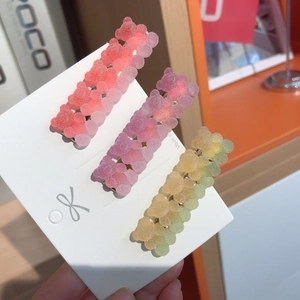 Three gradient gummy bear hair clips in pink purple and yellow resin on display card