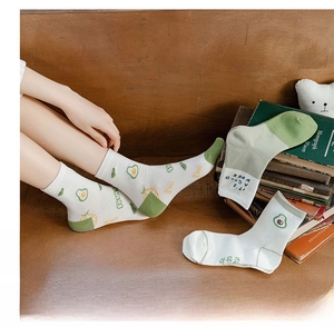 Detail view of cotton mid-calf socks with avocado embroidery and ribbed texture cuffs
