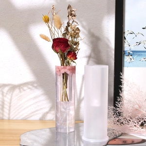 Macro detail of tall cylindrical silicone mold and finished floral resin vase sample
