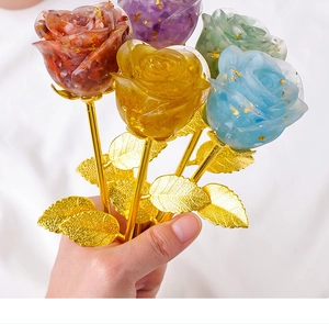 Close-up of colorful crystal resin roses with gold leaf flakes and golden metal stems