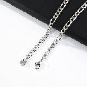 Detail of silver stainless steel Figaro chain showing lobster clasp and extender
