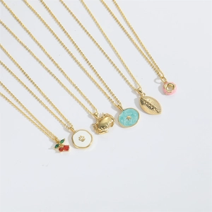 Detail shot of ocean themed gold crab, cherry, and starfish pendant necklaces set