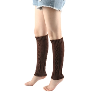 Close-up of brown cable-knit leg warmers with ribbed cuffs on model's legs