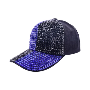 Detailed view of dense blue and black rhinestones on a stylish six-panel baseball cap