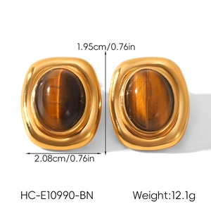 Detail view of retro gold earrings with oval tiger eye stone including size specifications