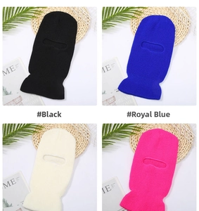 Flat lay of knit balaclava face masks in black, blue, cream, and rose red colors
