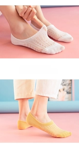 Detailed macro view of thin mesh structure on white and yellow low cut boat socks