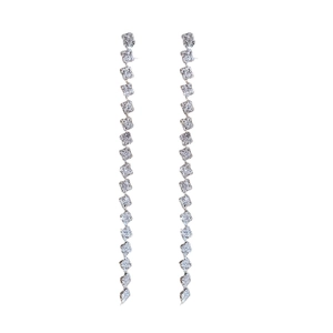Silver drop earrings with square floral elements and shimmering crystal tassels on white background