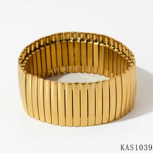 Detail of gold-plated stretch bracelet featuring ribbed metal rectangular segments