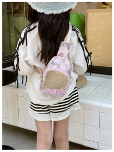 Girl wearing pink crossbody bag with a transparent pocket featuring colorful moving sequins
