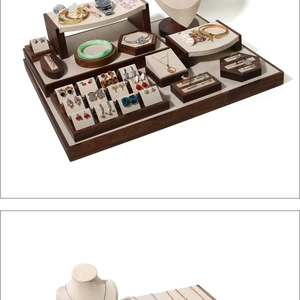 Detailed macro view of walnut wood jewelry display set with beige microfiber lining