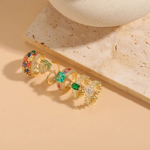 Detail of 14K gold plated rings set with colorful zircons and palm leaf patterns