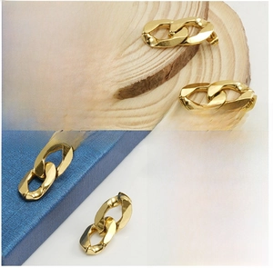 Détails macro des boucles d'oreilles en chaîne plaquées or 18 carats avec finition polie