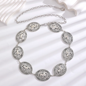 Detail of vintage silver metal waist chain featuring embossed horse oval medallions