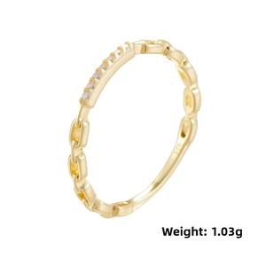 Macro view of gold chain ring with small zircons and 925 silver hallmark engraving