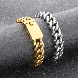 Close-up of gold and silver 15mm stainless steel Cuban link bracelets on a display