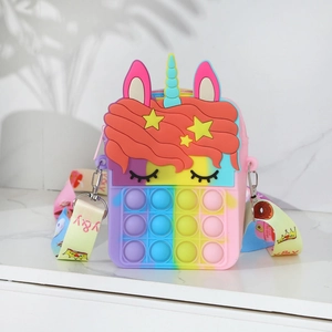Close-up of rainbow unicorn silicone pop fidget crossbody bag on marble surface
