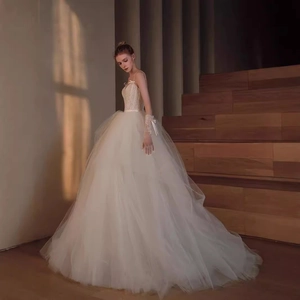 French lace wedding dress with spaghetti straps and voluminous layered tulle skirt