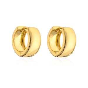 Close-up of polished gold-plated huggie hoop earrings with a mirror finish reflection