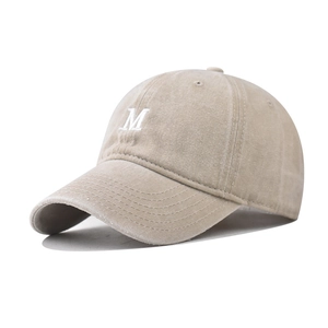Detailed close-up of the vintage washed cotton texture and white M letter embroidery