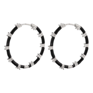 Detail of silver hoop earrings with black enamel and clear square cubic zirconia stones