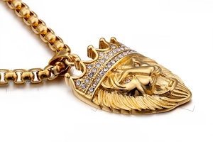 Macro view of 18K gold plated lion head pendant with sparkling white rhinestones