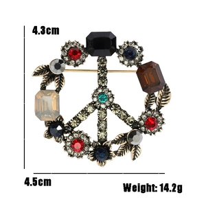 Vintage gold peace sign brooch with colorful rhinestones and floral details, 4.5cm wide